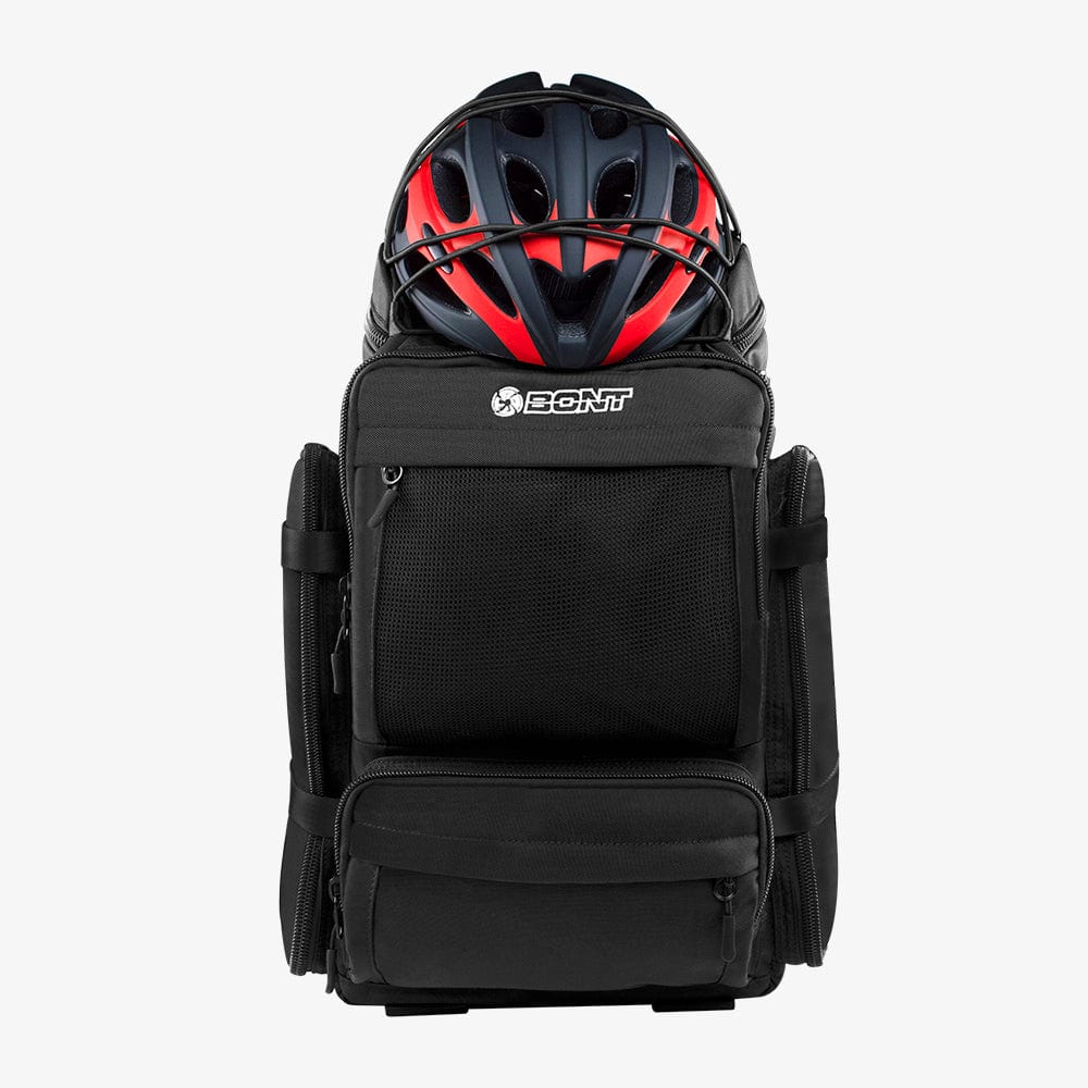 Front view of the black skate backpack with a helmet in the open main compartment.