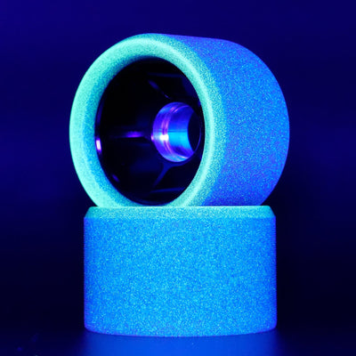 Side view of Royal Assassin Indoor UV roller skate wheel glowing in low light